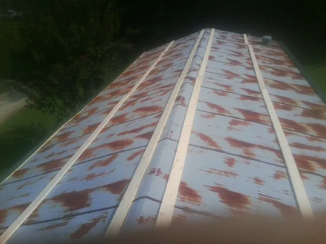 Rusted metal roof panels with new wood purlins before replacement — Storm Damage Roof Repair in Keansburg by Roofing Brothers